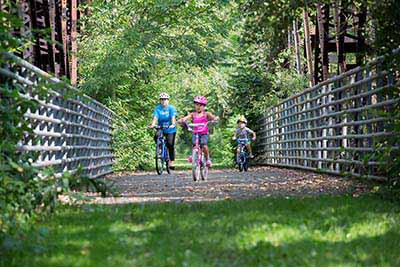 Pat McGee Trail - Family riding the trail through Little Valley, NY